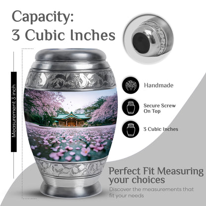 Pearl White Cherry Blossom Cremation Urn lifestyle display on memorial shelf - majestic cherry blossom pattern with filigree border - mini keepsake memorial for portion of cremation ashes