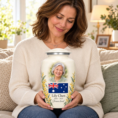 Seated person holding the ivory adult Ivory Wattle Remembrance Australian flag urn on their lap.