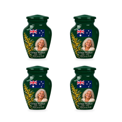 Four matching emerald green ringless keepsake urns with Australian flag artwork and fictional sample personalization.