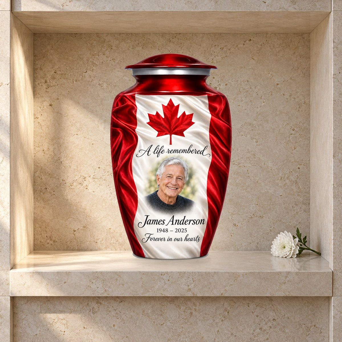 Red adult urn with Maple Silk Tribute Canadian flag artwork displayed in a columbarium niche.
