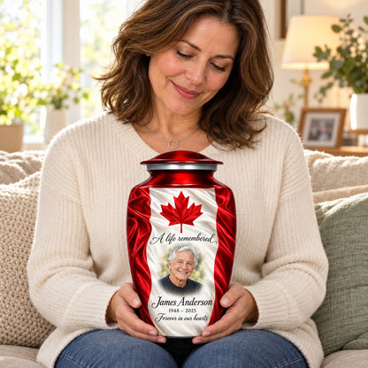 Seated person holding the red adult Canadian flag urn on their lap.