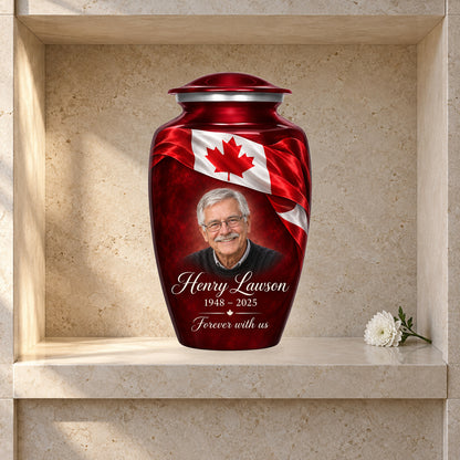 Red adult urn with Crimson Ribbon Remembrance Canadian flag artwork displayed in a columbarium niche.