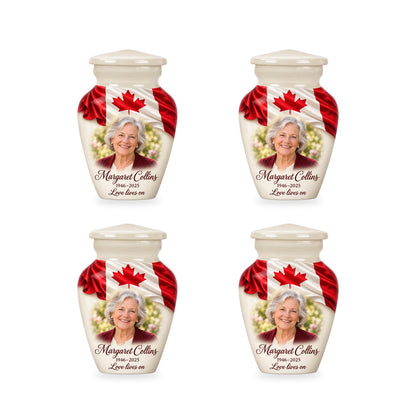 Four matching white Canadian flag keepsake urns with sample photo and inscription.