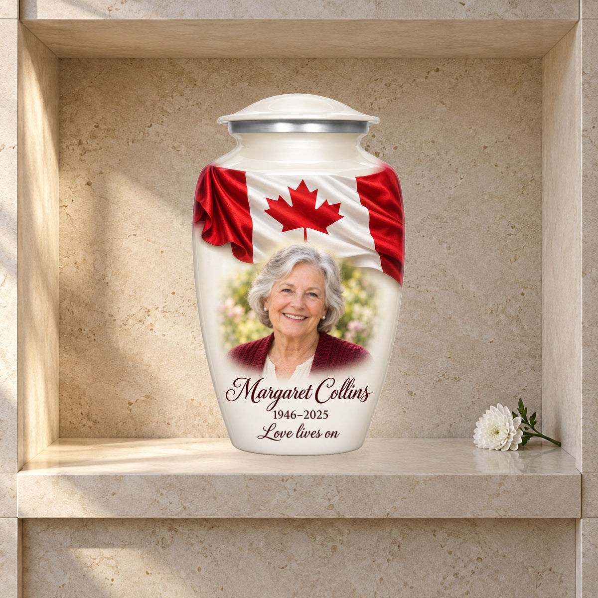 White adult urn with Ivory Folded Flag Tribute Canadian flag artwork displayed in a columbarium niche.