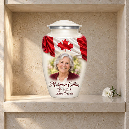 White adult urn with Ivory Folded Flag Tribute Canadian flag artwork displayed in a columbarium niche.