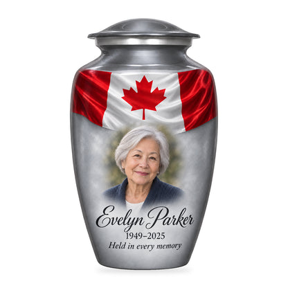 Gray adult urn with Silver Flag Remembrance Canadian flag artwork, fictional sample portrait and personalized inscription on white.