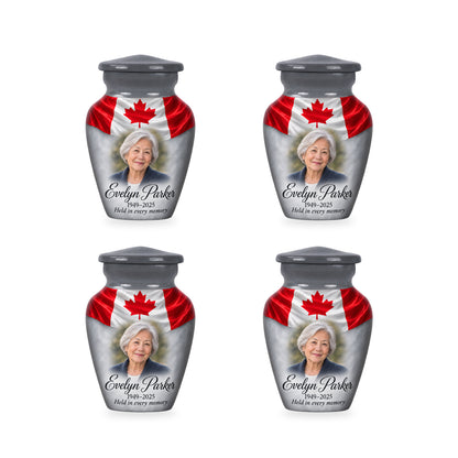 Four matching gray Canadian flag keepsake urns with sample photo and inscription.