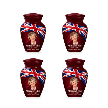 Four matching burgundy red ringless keepsake urns with diagonal Union Jack ribbon and fictional sample personalization.