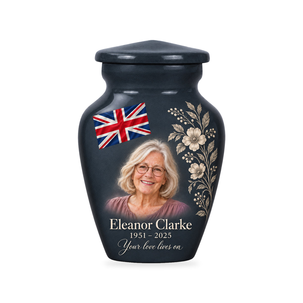 One slate gray ringless 3-inch keepsake urn with diagonally draped Union Jack and printed botanical linework, a fictional sample portrait and inscription on white.