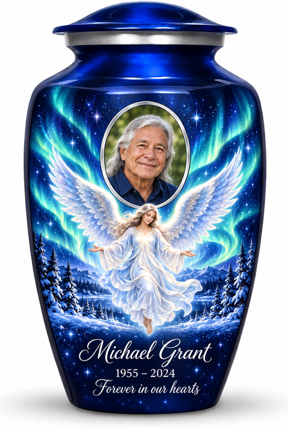 Blue adult urn with a floating angel, aurora sky, snowy trees and an oval sample portrait frame, sample name, dates and tribute.