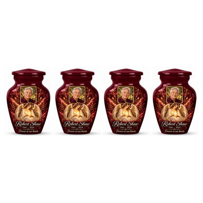 Four matching red angel keepsake urns with sample photo personalization on a white background.