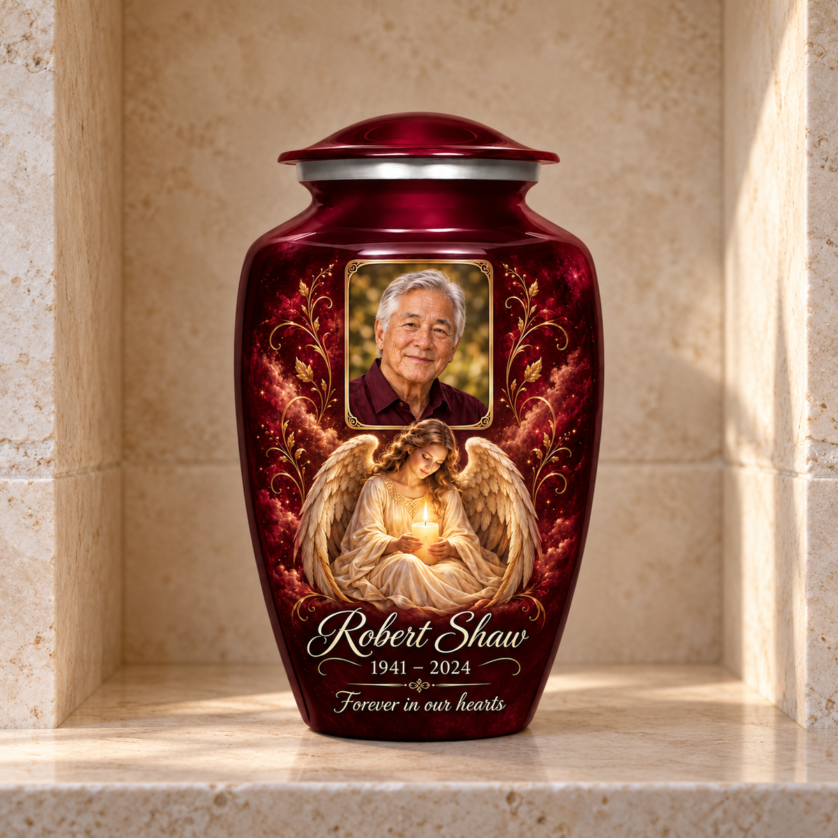 Red adult urn with a seated angel holding a candle and a rectangular sample portrait frame, displayed in a columbarium niche.