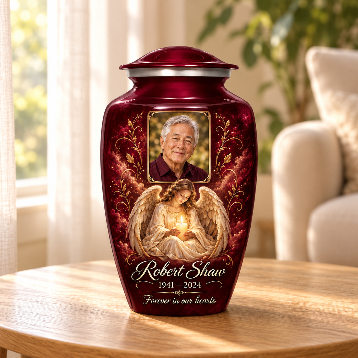 Red adult urn with a seated angel holding a candle and a rectangular sample portrait frame, displayed in a sunlit home.