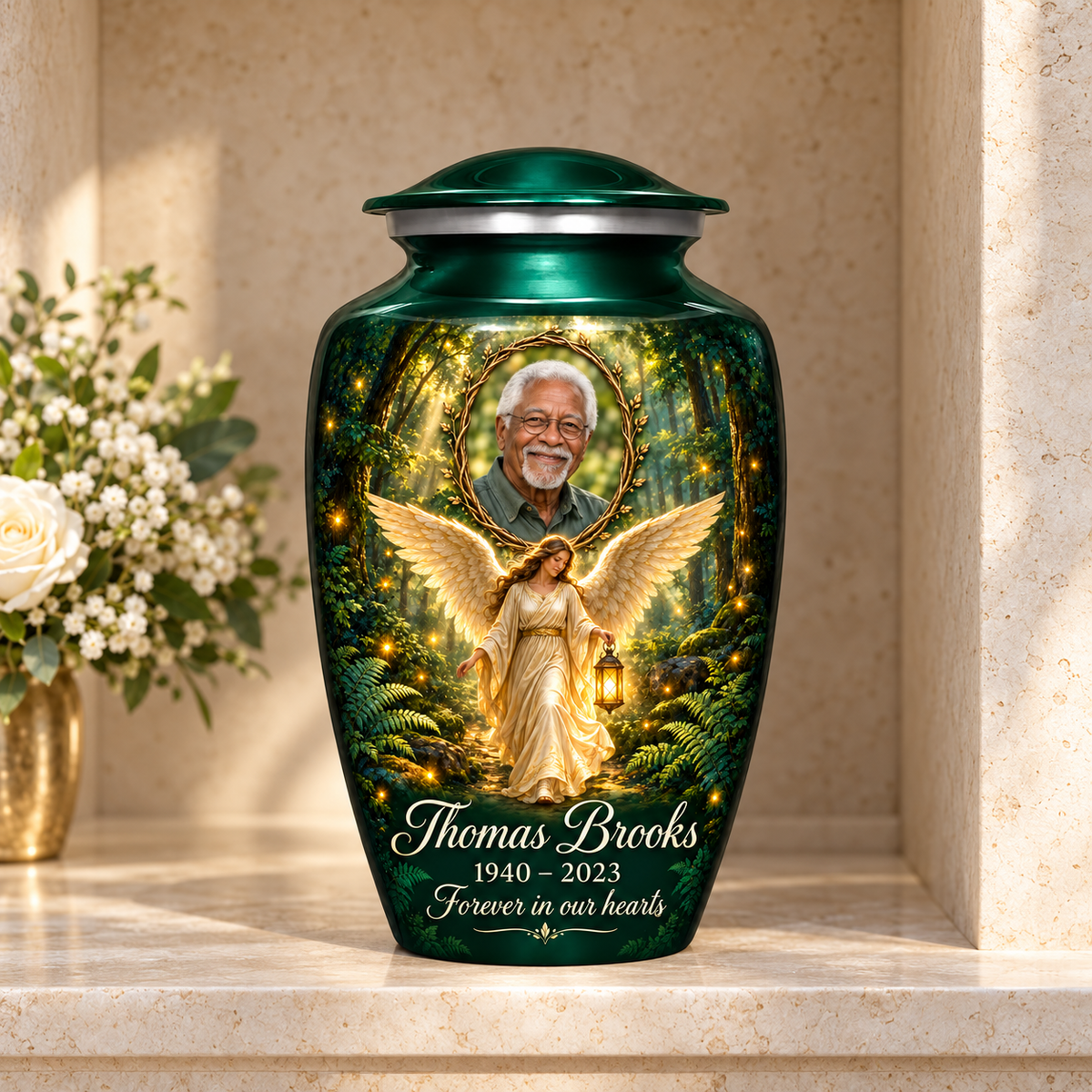 Green adult urn with a woodland angel holding a lantern and a twig framed sample portrait, displayed in a columbarium niche.
