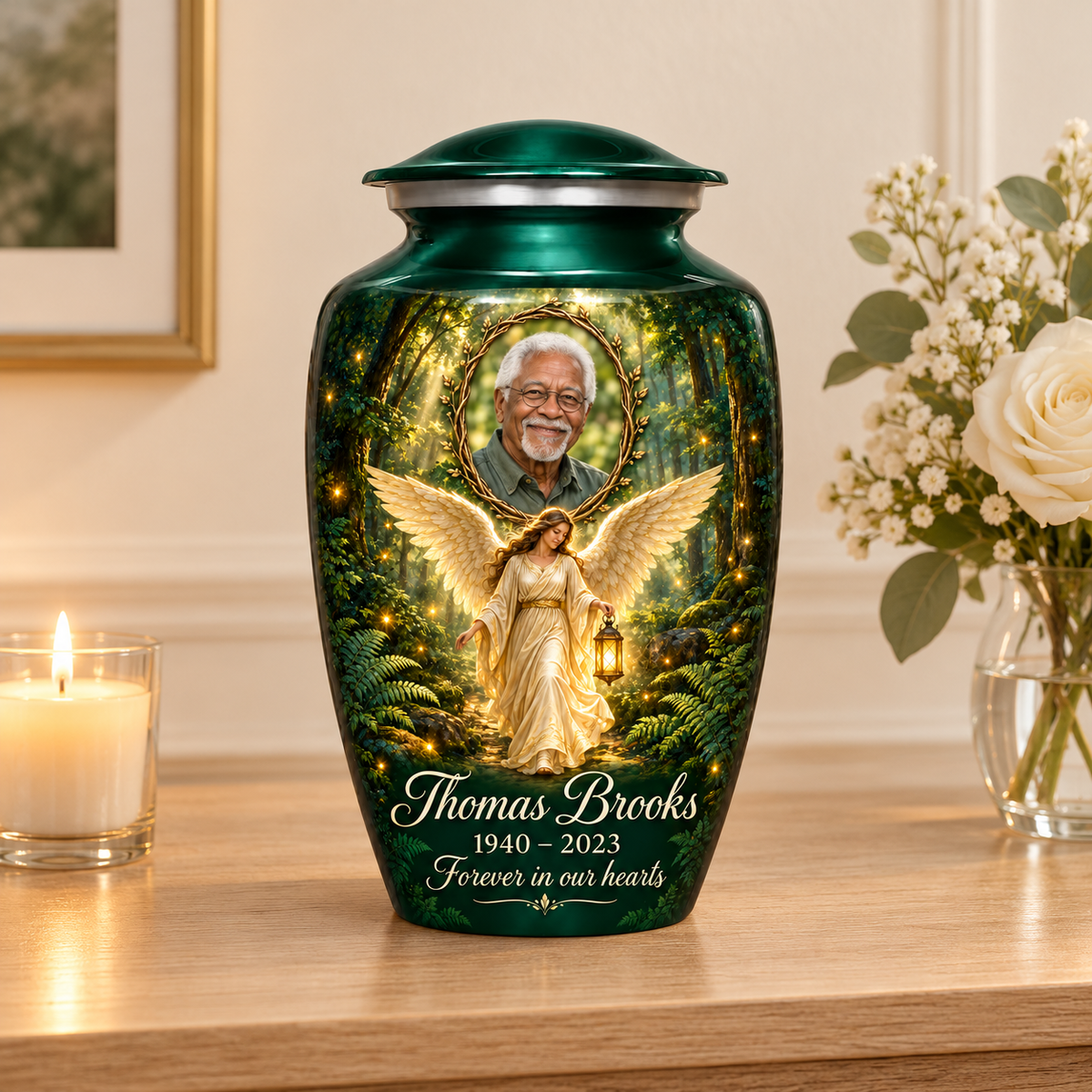 Green adult urn with a woodland angel holding a lantern and a twig framed sample portrait, arranged on a memorial console.