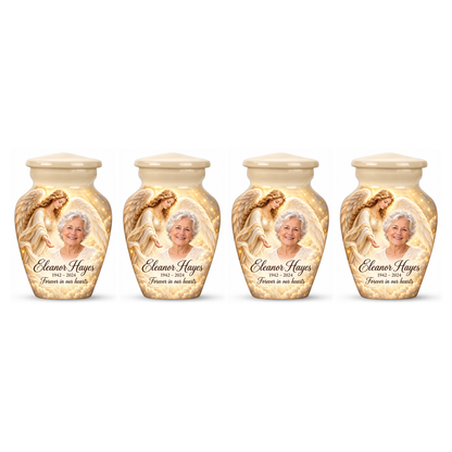 Four matching white angel keepsake urns with a guardian angel, golden clouds and light on white.