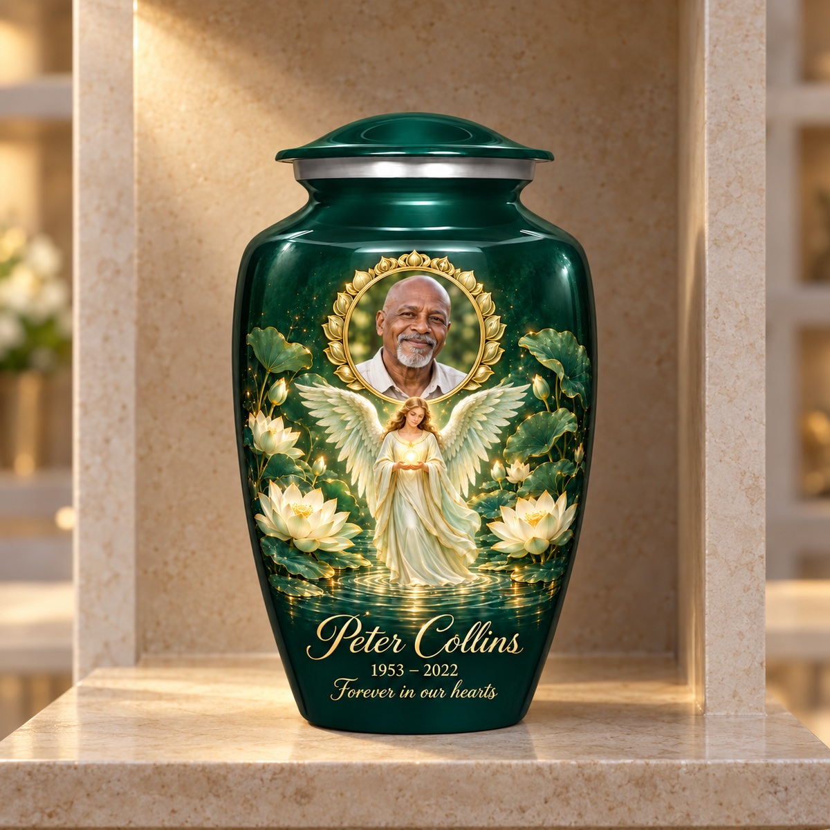 Green adult urn with an angel holding an orb above lotus water and a circular sample portrait frame, displayed in a columbarium niche.