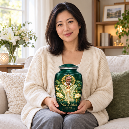 A seated person holding the green angel urn with an angel holding an orb above lotus water and a circular sample portrait frame on their lap.