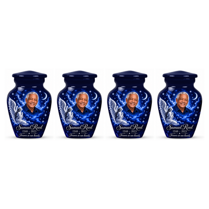 Four matching blue angel keepsake urns with a kneeling angel, stars and crescent moon on white.