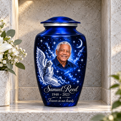 Blue adult angel urn with a kneeling angel, stars and crescent moon displayed in a columbarium niche.