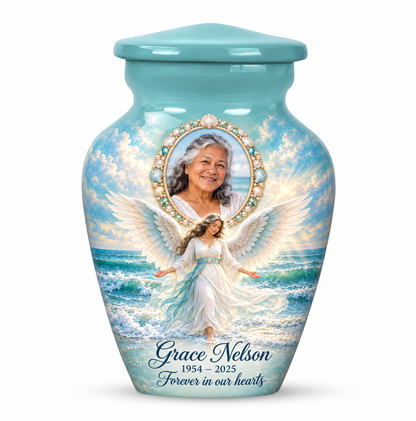 One blue angel keepsake urn with an ocean angel among waves and a shell style oval sample portrait frame and sample name and dates.