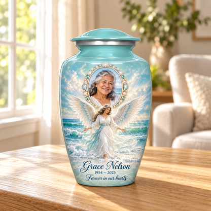 Blue adult urn with an ocean angel among waves and a shell style oval sample portrait frame, displayed in a sunlit home.