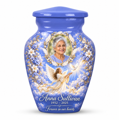 One blue angel keepsake urn with an angel releasing a dove and a feather and laurel sample portrait frame and sample personalization.