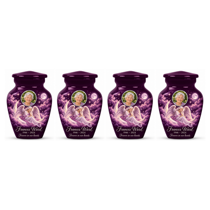 Four matching purple angel keepsake urns with sample portraits and inscriptions on white.