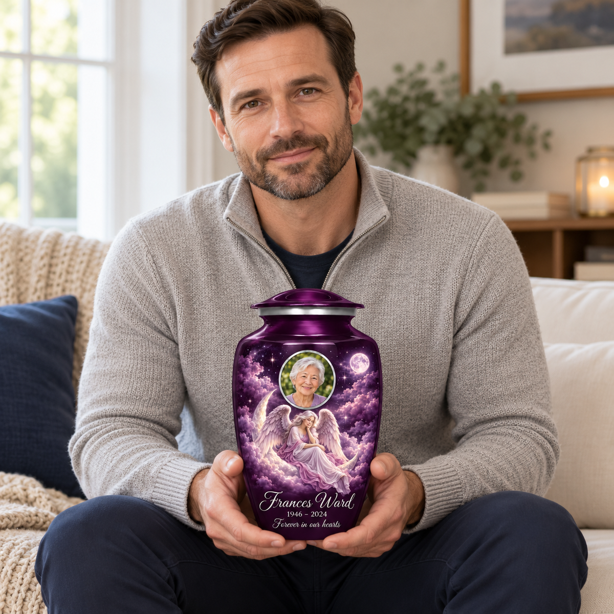 A seated person holding the purple angel urn with a seated angel on a crescent cloud, moonlit sky and an oval sample portrait frame on their lap.