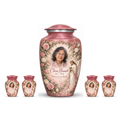 One pink adult angel urn and four keepsakes with an angel holding a white rose amid pink flowers on white.