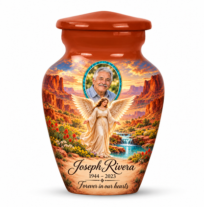 One orange angel keepsake urn with an angel beside a desert spring, distant mesas and a turquoise sample portrait frame and sample personalization.